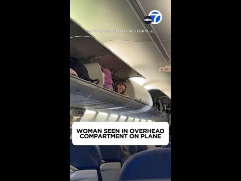 Video: Woman seen in overhead compartment on plane
