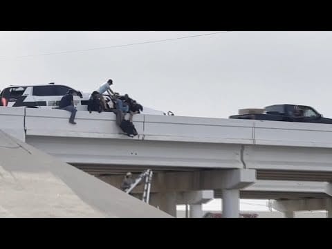 Video:  Deputy left dangling from overpass after semi rams into cruiser